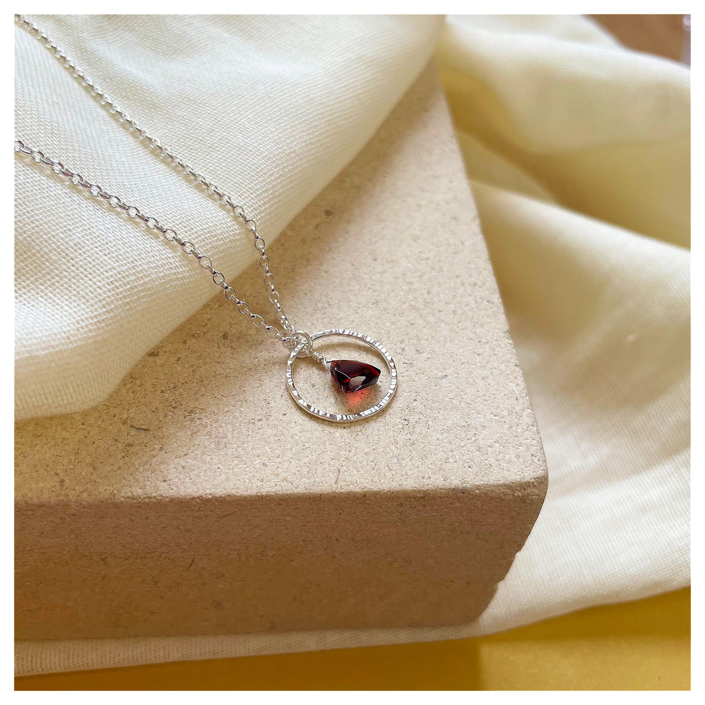 Mini Sterling Silver Hammered Circle and Garnet Trilliant Broilette Necklace.