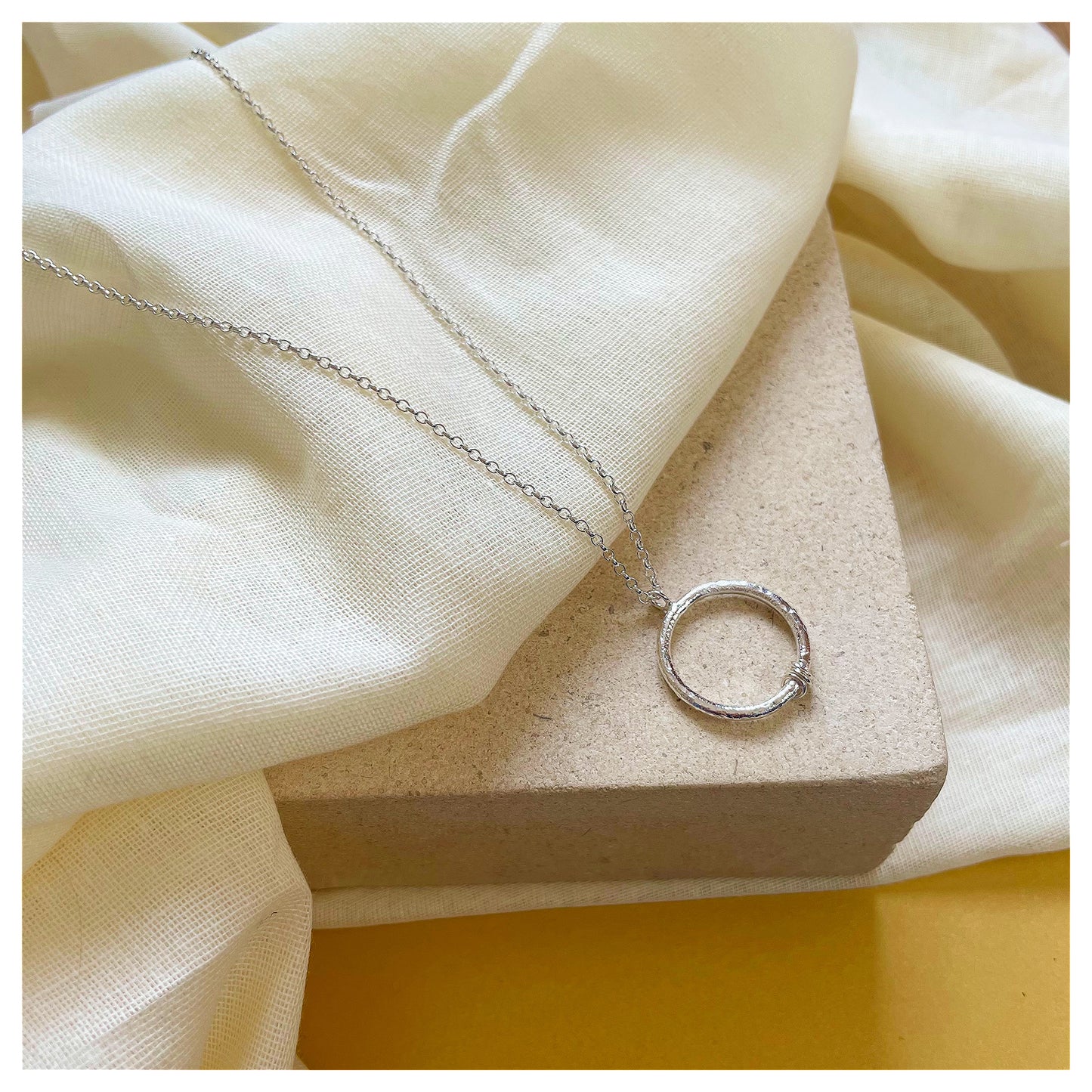 Sterling Silver Textured Circle Pendant With Ring Detail.