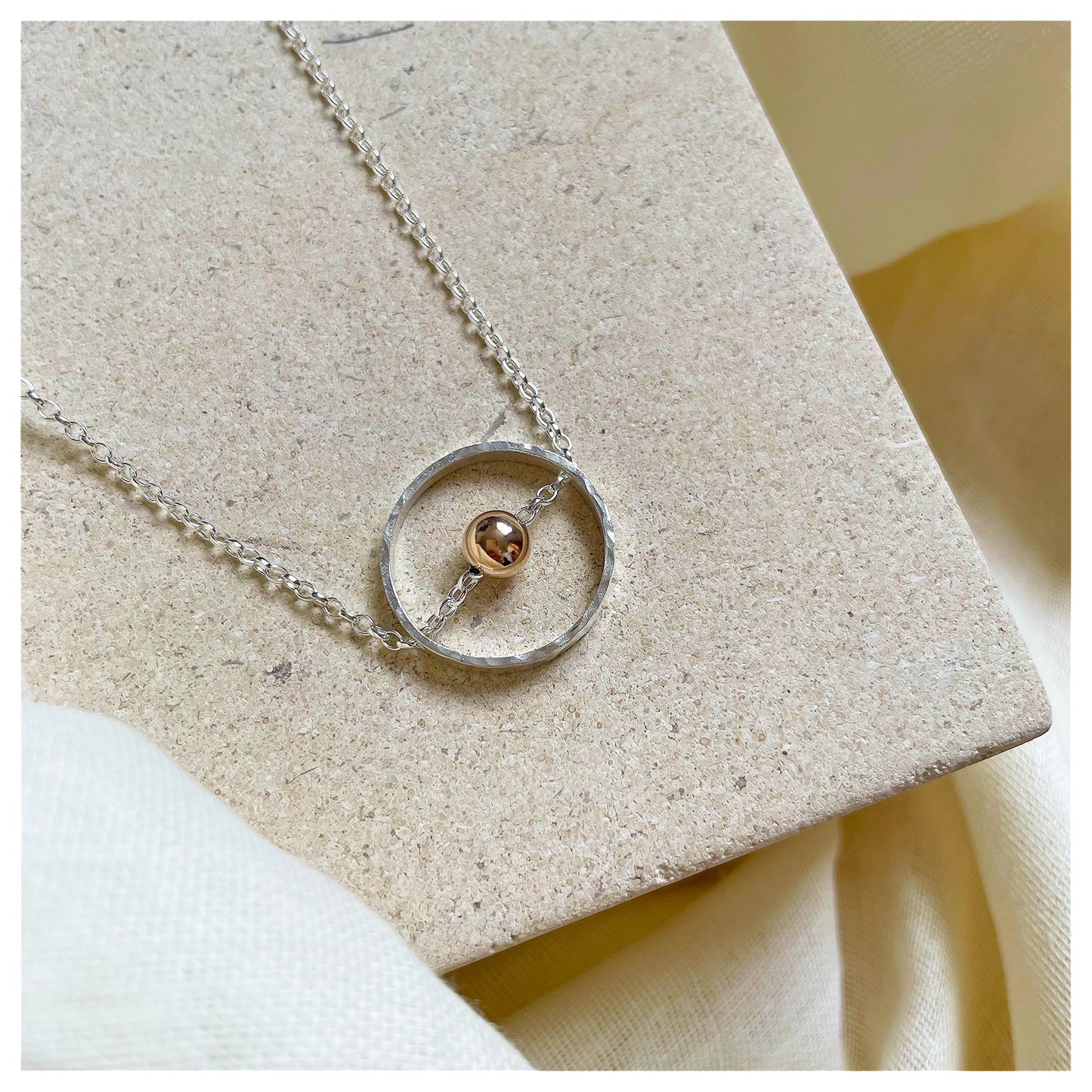 Sterling Silver Circular Pendant Necklace with 9ct Gold Bead.