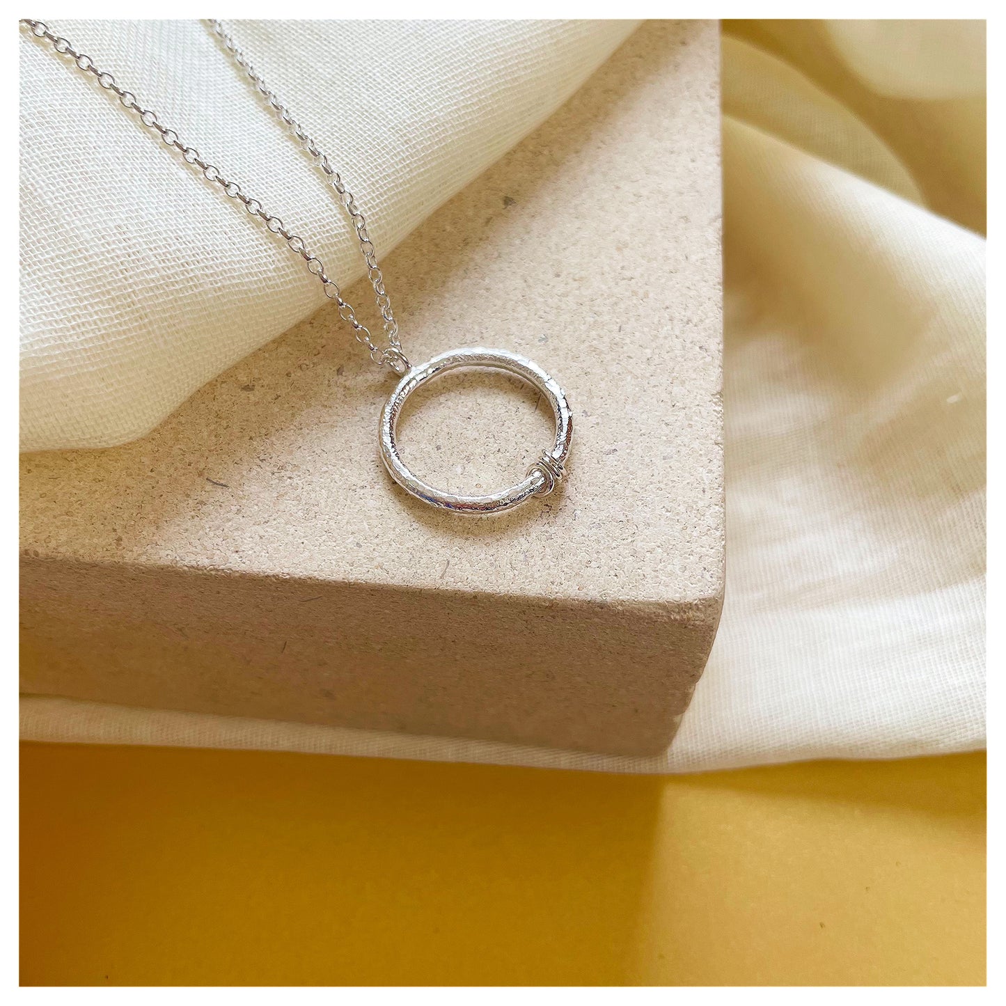 Sterling Silver Textured Circle Pendant With Ring Detail.