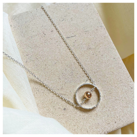 Sterling Silver Circular Pendant Necklace with 9ct Gold Bead.