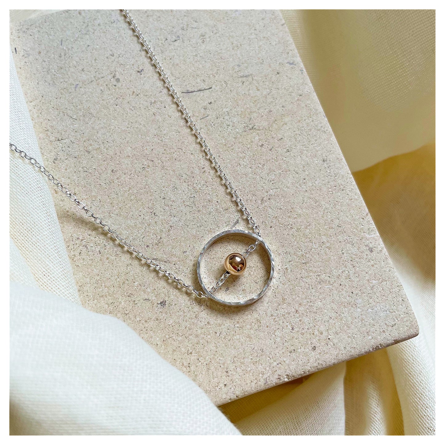 Sterling Silver Circular Pendant Necklace with 9ct Gold Bead.